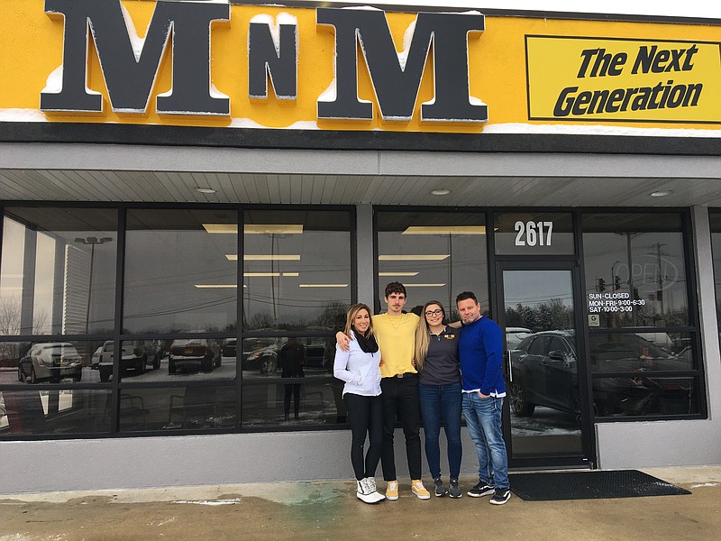 From left to right, Tish, Cross, Machale and Brian Mallicoat pose in front of MNM The Next Generation, at 2617 Missouri Blvd. Brian and Tish closed MNM Auto Sales in 2018, and their children, Machale and Cross, reopened the business in January under a new name, MNM The Next Generation. Photo by Nicole Roberts/News Tribune