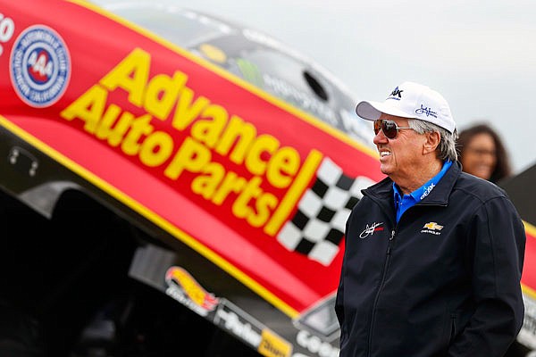 In this May 21, 2018, file photo, NHRA Funny Car legend John Force paces the staging lanes near his daughter Courtney's car prior to the semifinals of the NHRA Heartland Nationals at Heartland Motorsports Park in Topeka, Kan.