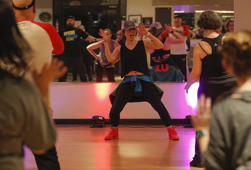 Liv Paggiarino/News TribuneJennifer Su Lucio pumps up her Zumba class Jan. 22 at the Capital Ritz Banquet & Dance Center.