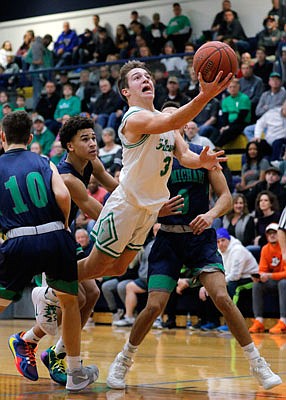 Jake Closser of Blair Oaks lunges for a shot in the lane during Saturday's game against St. Michael the Archangel in the Central Bank Shootout at Rackers Fieldhouse.