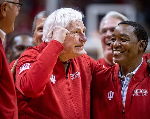 Former Indiana basketball coach Bobby Knight stands along with former player Isiah Thomas on the court during a ceremonySaturday with the Indiana players of the 1980 Big Ten championship team in Bloomington, Ind.