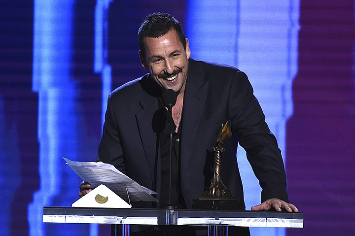 Adam Sandler accepts the award for best male lead for "Uncut Gems" at the 35th Film Independent Spirit Awards on Saturday, Feb. 8, 2020, in Santa Monica, Calif. (AP Photo/Chris Pizzello)