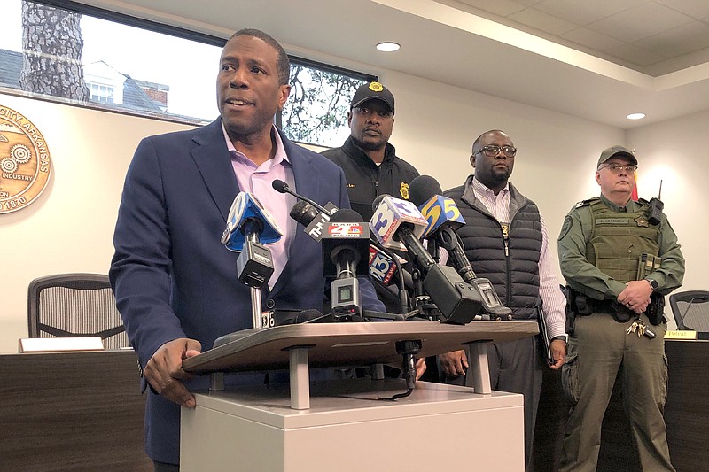 Forrest City, Ark., Mayor Cedric Williams, left, holds a news conference after two police officers were wounded and a gunman was killed in an exchange of gunfire at a Walmart store in eastern Arkansas Monday morning Feb. 10, 2020. Williams said that the officers were hospitalized soon after the shooting at the store about 45 miles west of Memphis. (AP Photo/Adrian Sainz)