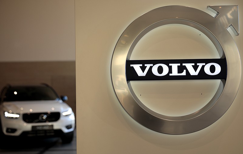 A Volvo car is parked behind the Volvo logo in the lobby of the Volvo corporate headquarters, prior to a media conference on the 2019 Full Year Financial Results, in Brussels, Thursday, Feb. 6, 2020. (AP Photo/Virginia Mayo)