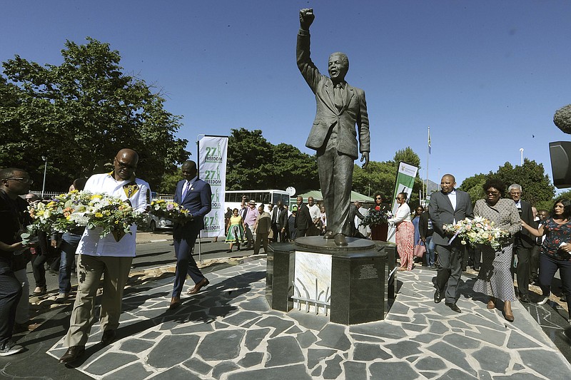 Wreaths are laid at a statue of former President Nelson Mandela at the entrance to the Victor Verster prison in Paarl, South Africa, Tuesday, Feb. 11, 2020. Thirty years ago, Nelson Mandela was released from 27 years of imprisonment at Victor Verster prison by South Africa's apartheid regime and instantly galvanized the country, and the world, to dismantle the brutal system of racial oppression. (AP Photo/Nasief Manie)