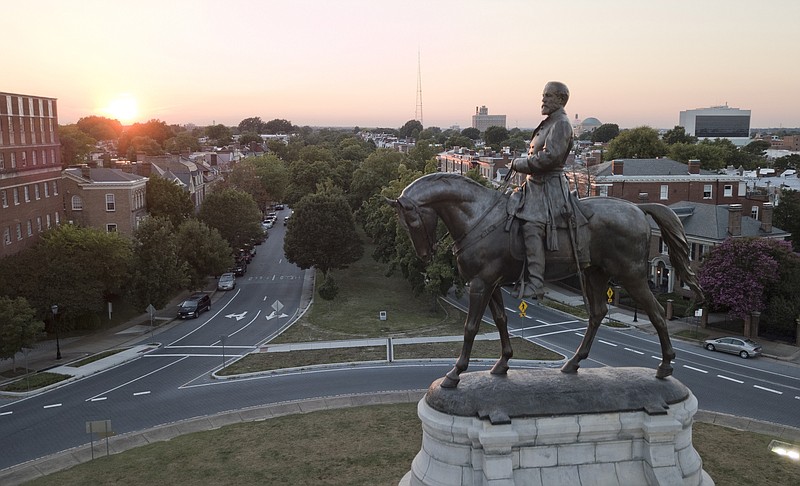 FILE - This July 31, 2017 file photo shows the statue of confederate General Robert E. Lee on Monument Avenue in Richmond, Va.  Local Virginia governments may soon have the power to remove Confederate monuments in their public spaces under legislation approved Tuesday, Feb. 11, 2020 by state lawmakers. Largely along party lines, the Democrat-led House and Senate passed measures that would give cities and counties the autonomy to "remove, relocate, contextualize, cover or alter” the monuments in their public spaces.(AP Photo/Steve Helber)