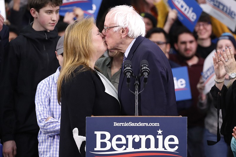 Democratic presidential candidate Sen. Bernie Sanders, I-Vt., kisses his wife Jane O'Meara Sanders, as he speaks to supporters at a primary night election rally in Manchester, N.H., Tuesday, Feb. 11, 2020. (AP Photo/Pablo Martinez Monsivais)