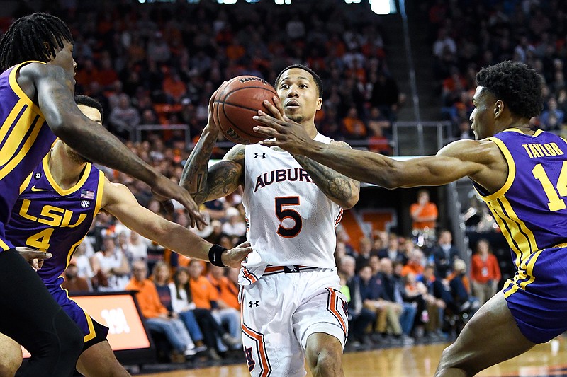 Auburn guard J'Von McCormick (5) drives past LSU guard Marlon Taylor (14) during the second half of an NCAA college basketball game Saturday, Feb. 8, 2020, in Auburn, Ala. (AP Photo/Julie Bennett)