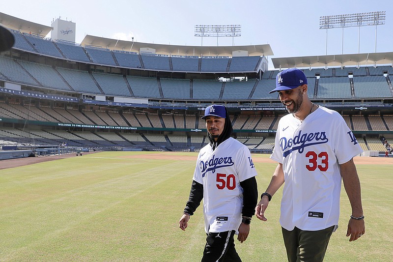 New Los Angeles Dodgers players David Price, right, and Mookie Betts walk after a news conference to announce their acquisition at Dodger Stadium in Los Angeles, Wednesday, Feb. 12, 2020. (AP Photo/Chris Carlson)