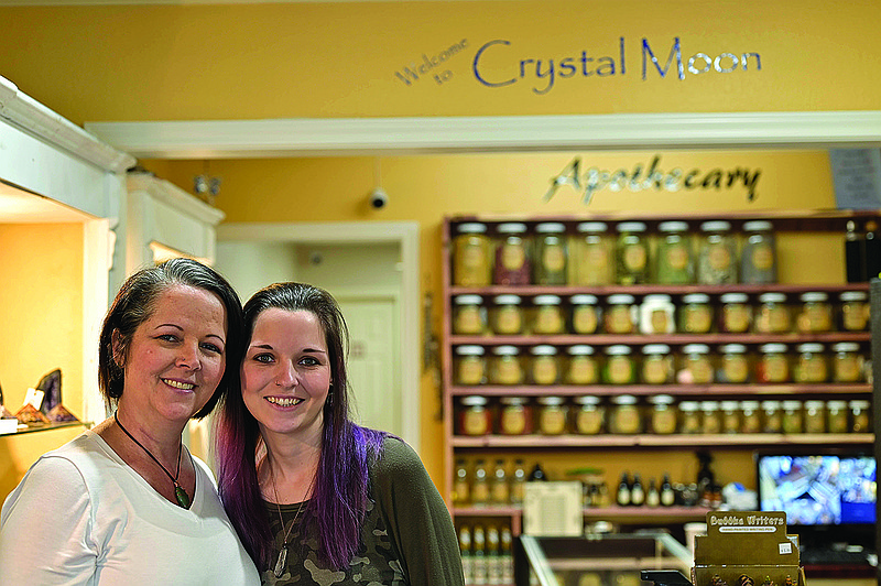 Sheila Lemley and her daughter-in-law, Lindsey Haynes, pose for a portrait at the entrance of the Crystal Moon Shop at 4150 McKnight Center in Texarkana, Texas. The metaphysical shop offers herbs, stones, incense, essential oils and more.