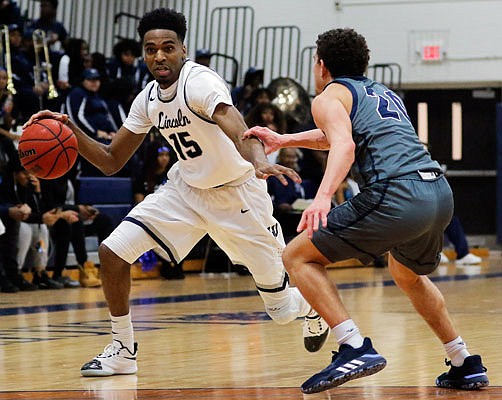 Jonell Burton of Lincoln dribbles past Washburn's Jalen Lewis during a game last month at Jason Gym.
