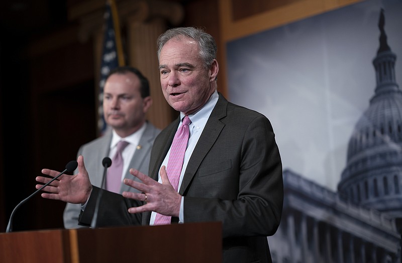 Sen. Tim Kaine, D-Va., joined at left by Sen. Mike Lee, R-Utah, meets with reporters just after the Senate advanced a resolution asserting that President Donald Trump must seek approval from Congress before engaging in further military action against Iran, at the Capitol in Washington, Wednesday, Feb. 12, 2020. (AP Photo/J. Scott Applewhite)