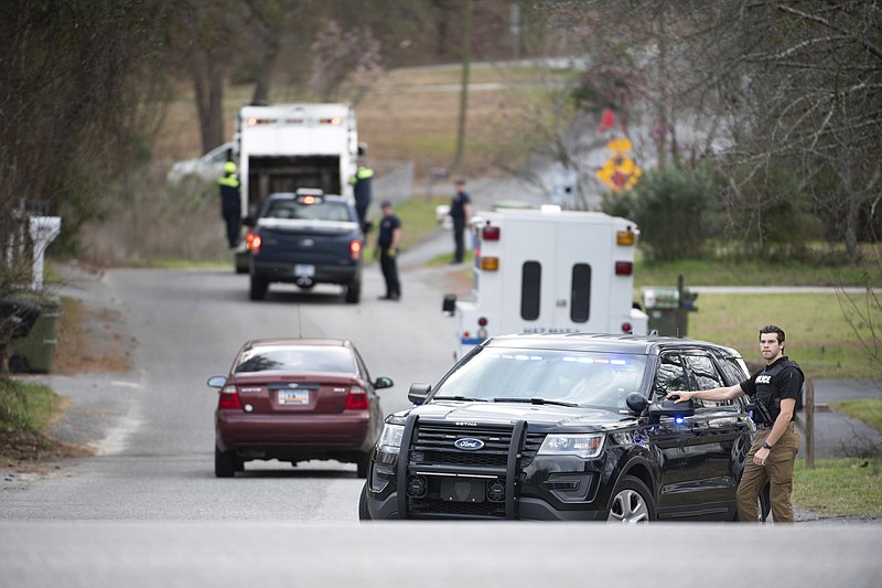 A Cayce police officer blocks an entrance to the Churchill Heights neighborhood Thursday, Feb. 13, 2020, in Cayce, S.C., where 6 year-old Faye Marie Swetlik recently went missing just after getting off a school bus. Hundreds of officers in Cayce, along with state police and FBI agents, are working around the clock to try to find Swetlik, who was last seen Monday, Cayce Public Safety Officer Sgt. Evan Antley reiterated Thursday. (AP Photo/Sean Rayford)