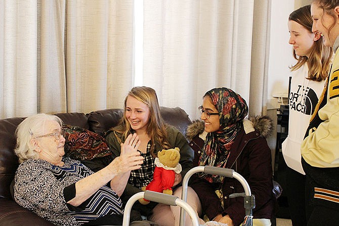 Fulton High School Student Council members present stuffed bears Thursday to Fulton Manor Care Center residents.