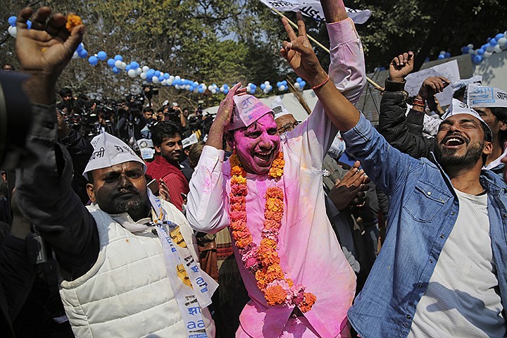 Supporters of the Aam Aadmi Party, or "common man's" party, celebrate the party's victory, at their party office in New Delhi, India, Tuesday, Feb. 11, 2020. Indian Prime Minister Narendra Modi's Hindu nationalist party was facing a major defeat by the regional party Tuesday in elections in the national capital that were seen as a referendum on Modi's policies such as a new national citizenship law that excludes Muslims. (AP Photo/Altaf Qadri)