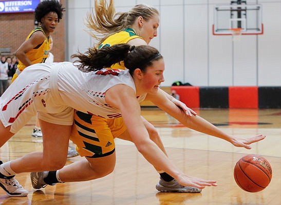 Hannah Linthacum of Jefferson City dives for a loose ball along with Eryn Puett of Rock Bridge during the second half of Thursday night's game at Fleming Fieldhouse.