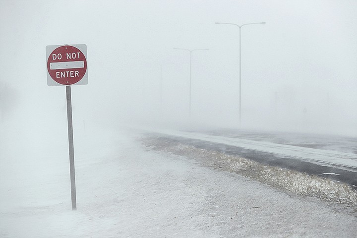 In this Wednesday, Feb. 12, 2020, photo, the driving lanes of U.S. Highway 281 north of Aberdeen, S.D., near Aberdeen Health and Rehab, were hard to see in the morning as high winds and blowing snow created blizzard and near white out conditions. (John Davis/Aberdeen American News via AP)