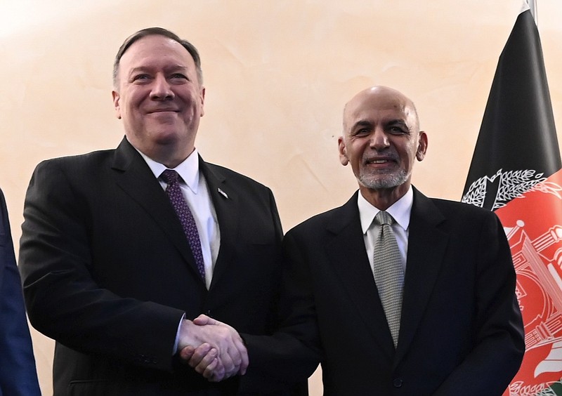 US Secretary of State Mike Pompeo, left, shakes hands with Afghan President Ashraf Ghani,during the 56th Munich Security Conference (MSC) in Munich, southern Germany, on Friday, Feb. 14, 2020. The 2020 edition of the Munich Security Conference (MSC) takes place from Feb. 14 to 16. (Andrew Caballero-Reynolds/Pool photo via AP)