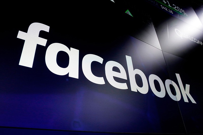 In this March 29, 2018 file photo shows the logo for Facebook at the Nasdaq MarketSite, in New York's Times Square.  Facebook on Friday, Feb. 14, 2020,  decided to allow a type of paid political message that sidesteps many of the social network's rules governing political ads.  Its policy change comes days after presidential candidate Michael Bloomberg exploited a loophole to run such humorous messages promoting his campaign on the accounts of popular Instagram personalities followed by millions of young voters.(AP Photo/Richard Drew, File)