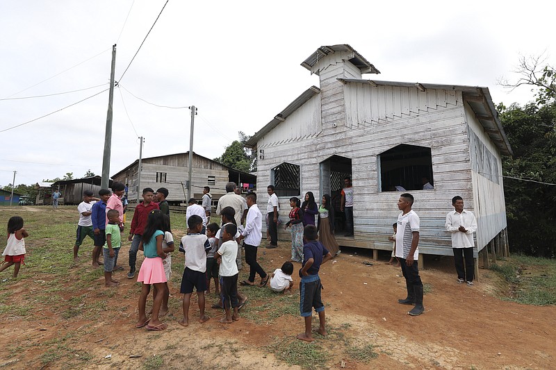 In this Sept. 22, 2019 file photo, residents gather outside the Catholic church of Novo Cruzador, Brazil, after attending a prayer led by missionary Antelmo Pereira on Sunday, Sept. 22, 2019. Roman Catholic priests, on Wednesday, Feb. 12, 2020, along with deacons and bishops across the Amazon voiced surprise, resignation and reluctant acceptance of Pope Francis' refusal to allow married men to be ordained priests, lamenting that their faithful will continue to be deprived of Mass and subject to competing evangelical churches that have made impressive inroads in the region.  (AP Photo/Fernando Vergara, File)