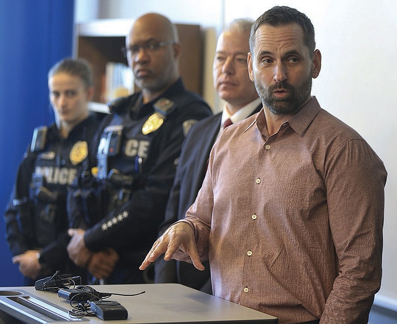 Pulaski County Special School District Superintendent Charles McNulty, right, joined by Sherwood Police Officers Jaclyn Vallor, left, and Jamal Hockaday, second from left, and FBI Assistant Special Agent in Charge Scott Reinhardt speaks Friday at Sylvan Hills High School in Sherwood about the arrests made stemming from online "hoax" threats against the school. (Arkansas Democrat-Gazette/Staton Breidenthal)
