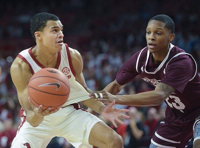 Arkansas Razorbacks guard Jalen Harris (5) looks for an opening as Mississippi State Bulldogs guard Tyson Carter (23) covers during a basketball game, Saturday, February 16, 2019 at Bud Walton Arena in Fayetteville. (NWA Democrat-Gazette/CHARLIE KAIJO) 

