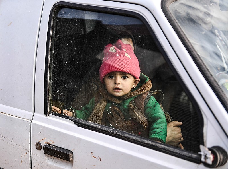 Civilians flee from Idlib toward the north to find safety inside Syria near the border with Turkey, Saturday, Feb. 15, 2020. Syrian troops are waging an offensive in the last rebel stronghold. (AP Photo)