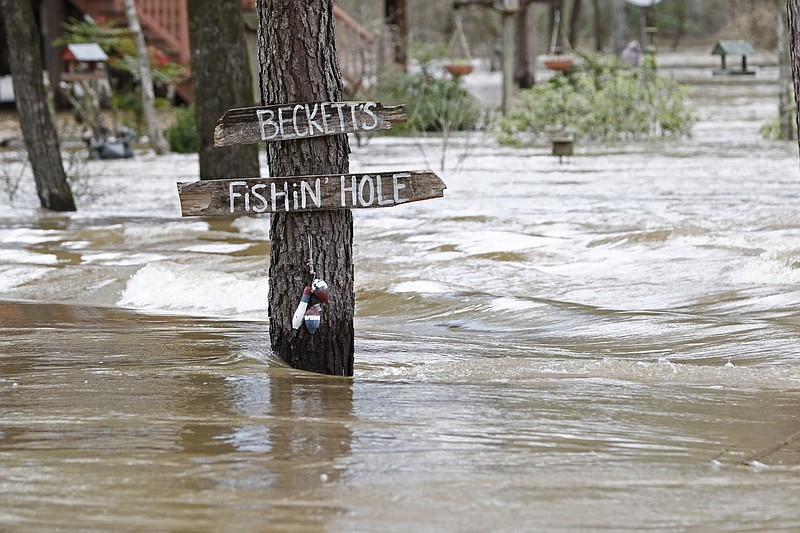 Water from the Pearl River floods Florence-Byram Road near Byram, Miss, Monday, Feb. 17, 2020. Authorities believe the flooding will rank as third highest, behind the historic floods of 1979 and 1983. (AP Photo/Rogelio V. Solis)