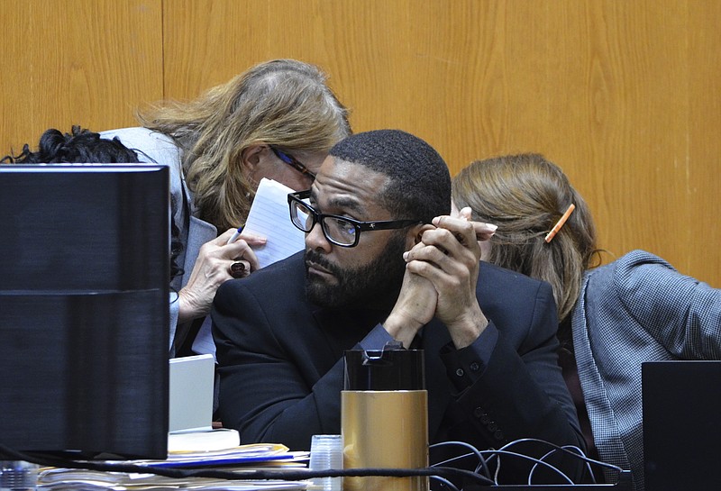 Defense attorneys Alison Steiner, left, and Katherine Poor, right, discuss behind Willie Cory Godbolt during the second day of testimony in the capital murder trial of Godbolt at the Pike County Courthouse in Magnolia, Miss., Sunday, Feb. 16, 2020. Opening arguments were made Saturday in the death penalty trial of Godbolt, accused of killing multiple people in Mississippi in May 2017. (Donna Campbell/The Daily Leader via AP, Pool)
