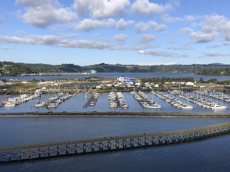 FILE - In this July 22, 2019, file photo, Oregon State University's Marine Studies Building, which is under construction in a tsunami inundation zone, is viewed from the Yaquina Bay Bridge in Newport, Ore. The building, center right, is surrounded by Yaquina Bay. The Oregon Legislature appears poised to continue to allow construction of critical facilities in tsunami inundation zones, a move slammed by critics. (AP Photo/Andrew Selsky, File)