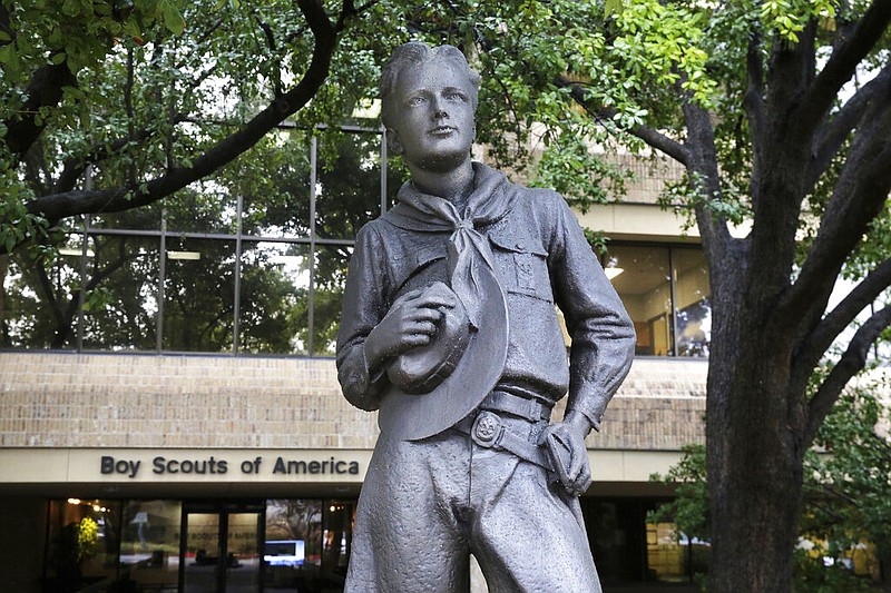 In this Wednesday, Feb. 12, 2020, photo, a statue stands outside the Boys Scouts of America headquarters in Irving, Texas. The Boy Scouts of America has filed for bankruptcy protection as it faces a barrage of new sex-abuse lawsuits. The filing Tuesday, Feb. 18, in Wilmington, Delaware, is an attempt to work out a potentially mammoth compensation plan for abuse victims that will allow the 110-year-old organization to carry on. (AP Photo/LM Otero)