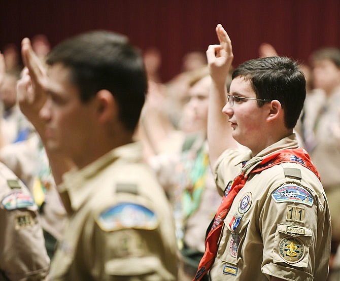 Quinton Frohman, 14, right, forms the Scout salute Monday by raising three fingers while repeating the Boy Scout oath during an awards ceremony on the floor of the House of Representatives. Frohman, of Troop 11 from First Baptist Church in Jefferson City, was one of 265 Eagle Scouts in the Capitol for Eagle Scout Day where they received the pocket knife that comes with attaining that high rank. For the fourth year, scouts and their family were seated in the House of Representatives chamber where they were addressed by representatives, scout leaders and Gov. Mike Parson before retreating to the third floor rotunda for a luncheon. 