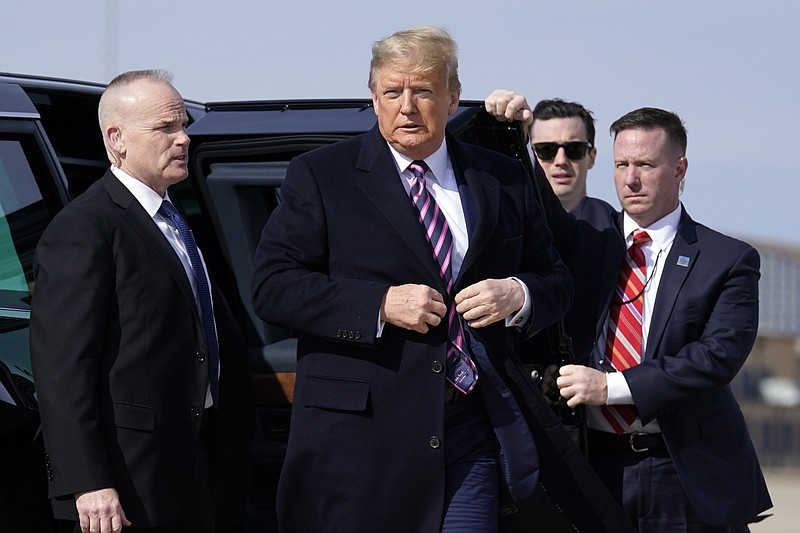 President Donald Trump walks over to talk to the media before he boards Air Force One for a trip to Los Angeles to attend a campaign fundraiser, Tuesday, Feb. 18, 2020, at Andrews Air Force Base, Md. (AP Photo/Evan Vucci)