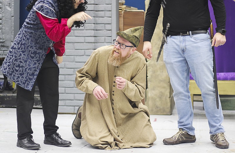 Liv Paggiarino/News Tribune

Ian Freeland, left, playing the Sheriff of Nottingham, and Mike Azar, left, who plays Sir Guy of Gisbourne, “intimidate” Joey Wyss, who plays Much the Miller, during a rehearsal for Ken Ludwig’s “Sherwood: The Adventures of Robin Hood,” directed by Laura Vedenhaupt, on Thursday, Feb. 6, at the Little Theatre of Jefferson City. 