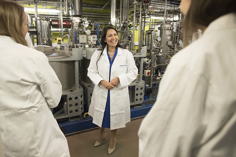 Britain's Home Secretary Priti Patel meets students and staff working on 'carbon capture' at Imperial College London in South Kensington, London, Tuesday Feb. 18, 2020. Britain has announced a new post-Brexit “points-based immigration system” said Patel, that will assess prospective immigrants on a range of skills, qualifications, salaries or professions, starting next year.  (Stefan Rousseau/PA via AP)