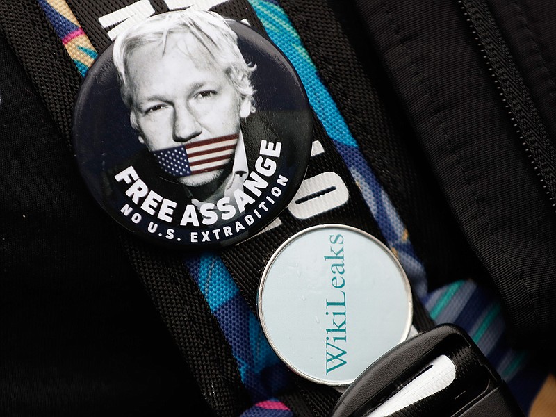 Badges worn by a demonstrator outside Westminster Magistrates Court in London, Wednesday, Feb. 19, 2020. A case-management hearing regarding Julian Assange will be heard at the court Wednesday. It comes just five days before the extradition hearing beginning Feb. 24, at Woolwich Crown Court, in which both Julian Assange and the broader issues of press freedom will be at stake. (AP Photo/Kirsty Wigglesworth)