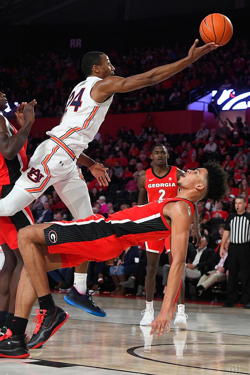 Auburn forward Anfernee McLemore (24) releases a shot as Georgia forward Toumani Camara tries to draw a charge during the first half of an NCAA college basketball game Wednesday, Feb. 19, 2020, in Athens, Ga. (AP Photo/John Amis)