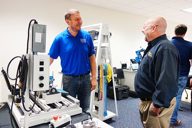 Ben Berhorst, an HVAC instructor with State Technical College of Missouri, shows Fulton Mayor Lowe Cannell training equipment that will be used in a new program. Missouri Apprenticeships in Manufacturing Program will offer free maintenance technician skills for unemployed, underemployed and low-skill individuals.