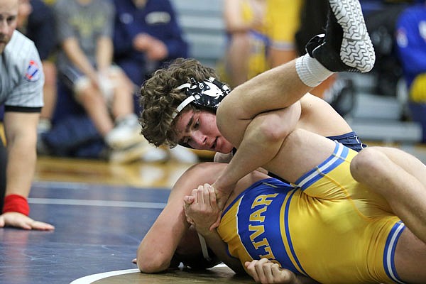 Alexsey Salaz of Helias tries to pin Bolivar's Riley Beckman during their 138-pound match in the Missouri Duals this season. Salaz is one of four state qualifiers for the Crusaders.