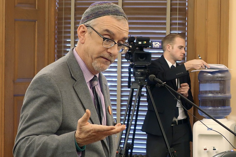 In this Wednesday, Feb. 19, 2020 photo, Rabbi Moti Rieber, executive director of the Kansas Interfaith Alliance, testifies against a bill to bar cities and counties from banning single-use plastic bags and straws, at the Statehouse in Topeka, Kan. Rieber says he's frustrated that lawmakers are considering such a measure and not having a meaningful conversation about climate change. (AP Photo/John Hanna)