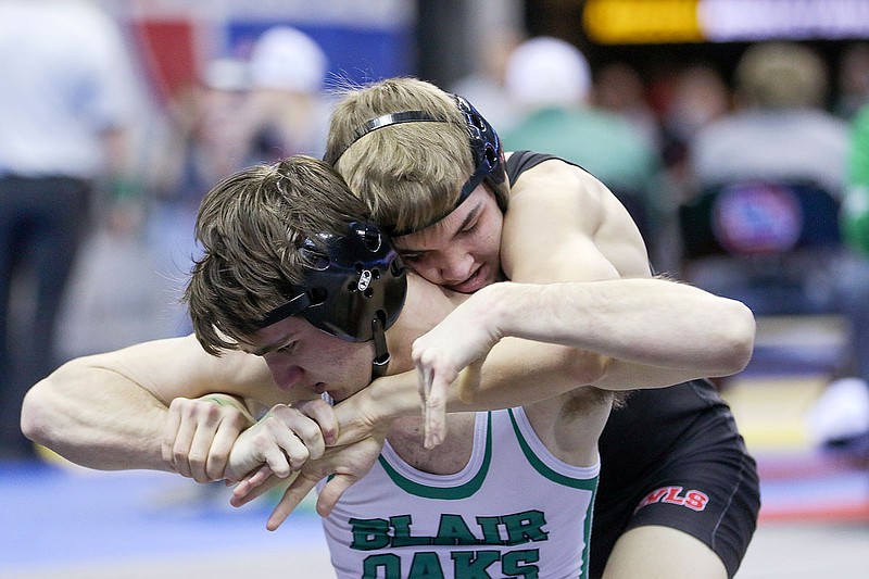 Blair Oaks' Caleb Meeks wrestles against Marshall's Isaac Jackson in a 132-pound match Thursday during the Class 2 state wrestling championships at Mizzou Arena in Columbia.