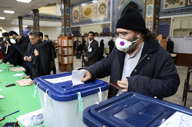 A voter casts his ballot in the parliamentary elections in a polling station in Tehran, Iran, Friday, Feb. 21, 2020. Iranians began voting for a new parliament Friday, with turnout seen as a key measure of support for Iran's leadership as sanctions weigh on the economy and isolate the country diplomatically. (AP Photo/Vahid Salemi)