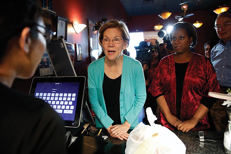 Democratic presidential candidate Sen. Elizabeth Warren, D-Mass., picks up food at EllaEm's Soul Food, Thursday, Feb. 20, 2020, in North Las Vegas, Nev. (AP Photo/John Locher)