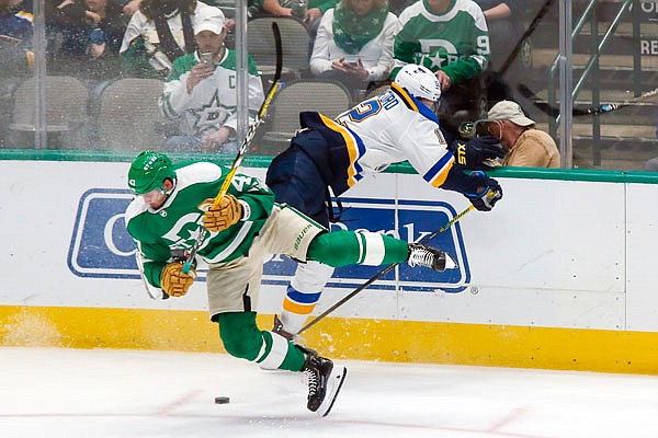Stars right wing Alexander Radulov is checked by Blues left wing Zach Sanford during the third period of Friday night's game in Dallas. The Blues won 5-1.