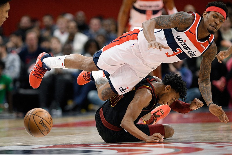 Cleveland Cavaliers guard Darius Garland, bottom, and Washington Wizards guard Bradley Beal are unable to come up with the ball during the second half of an NBA basketball game Friday, Feb. 21, 2020, in Washington. Garland was called for a foul on the play. The Cavaliers won 113-108. (AP Photo/Nick Wass)