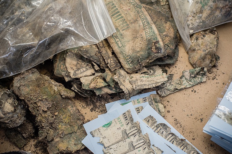 A pile of water-damaged bills sent to the Mutilated Currency Division of the Bureau of Engraving and Printing. Photographed Jan. 16, 2020, in Washington, D.C. (Photo for The Washington Post by Andr Chung)