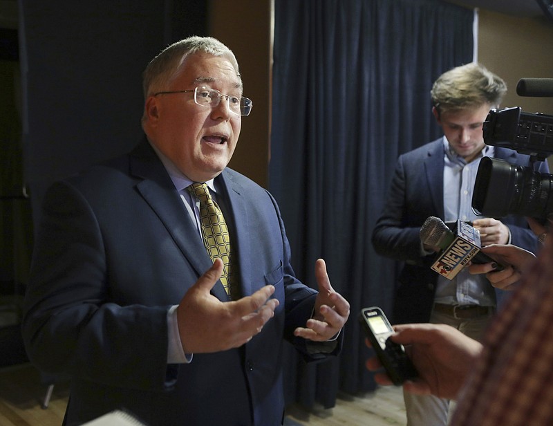 FILE - In this Nov. 1, 2018, file photo, Patrick Morrisey speaks to reporters after a debate in Morgantown, W.Va.  State attorneys general are finding a national settlement over the toll of opioids to be elusive, as some lawyers for state and local governments are renewing public criticism of the proposed deal with a group of companies led by the nation's largest drug distributors.  In a statement Friday, Feb. 21, 2020,  Morrisey, the attorney general in West Virginia, one of the states hit hardest by the opioid crisis, said the $22 billion in cash being offered by distributors AmerisourceBergen, Cardinal Health and McKesson plus drugmaker Johnson & Johnson “is way too low.”(AP Photo/Raymond Thompson, File)