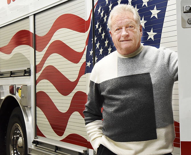 Bill Farr poses next to one of the Cole County Emergency Services vehicles Thursday. After 13 years as director of Cole County Emergency Management, Farr is set to retire at the end of February.