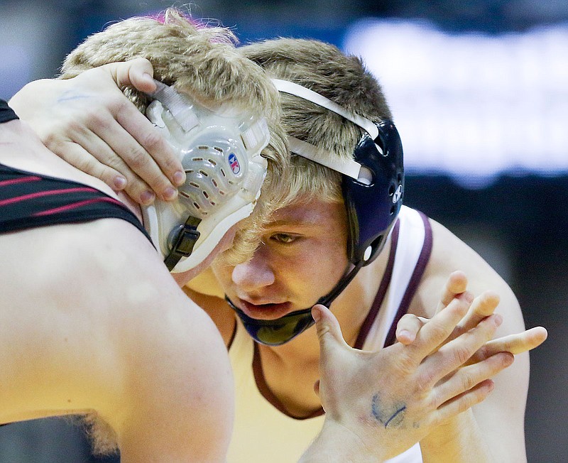 Chase Cordia of School of the Osage grasps the hand and neck of Odessa's Luke Malizzi during their 160-pound title match Saturday at the Class 2 state wrestling championships at Mizzou Arena.