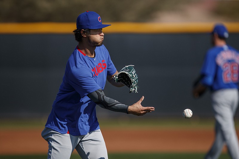 Cubs starter Yu Darvish tosses a ball during a spring training drill at Sloan Park in Mesa, Ariz., on Saturday, Feb. 15, 2020.